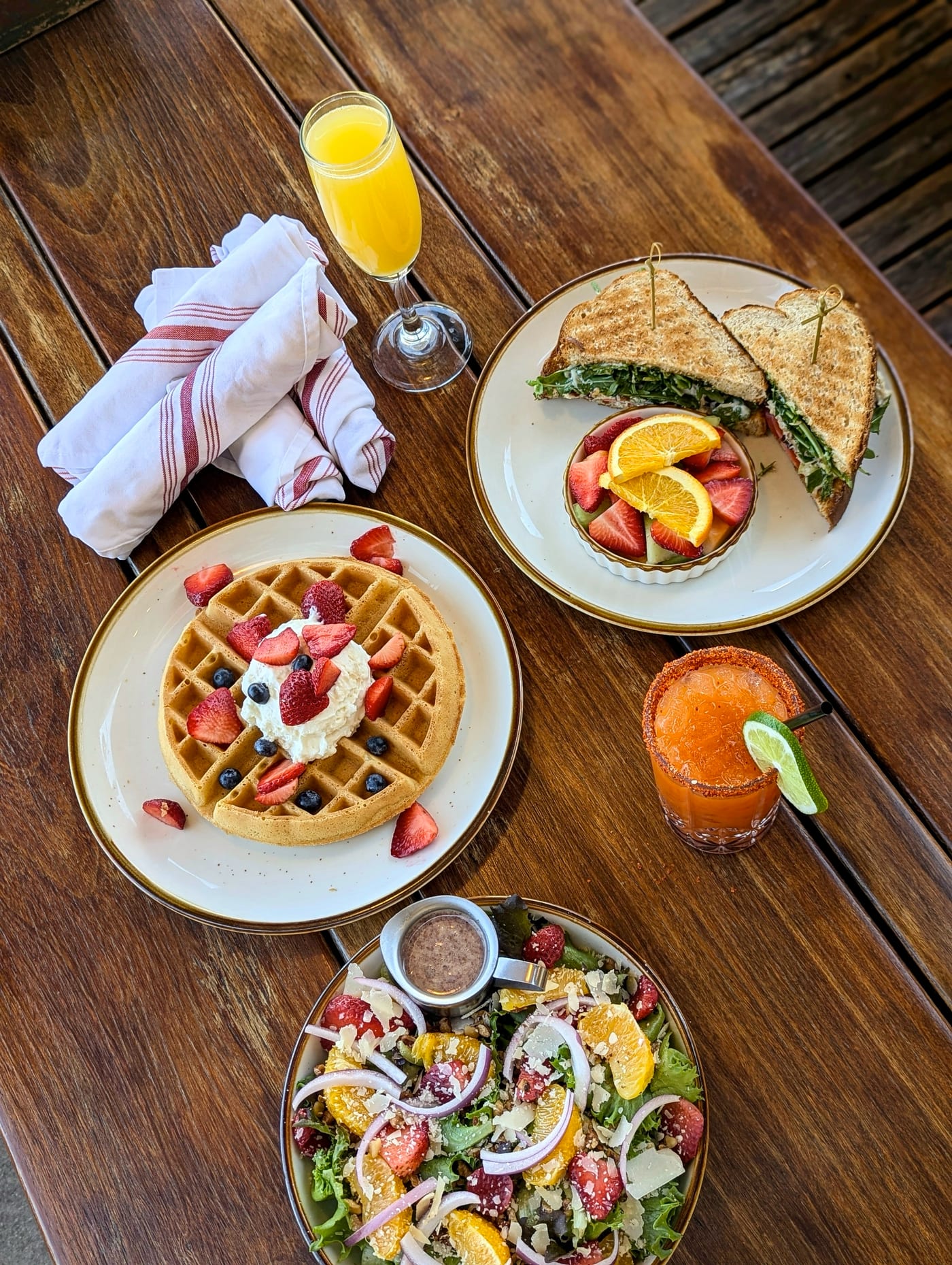 Brunch table spread with toast, salad and drinks. Root Cellar Cafe.