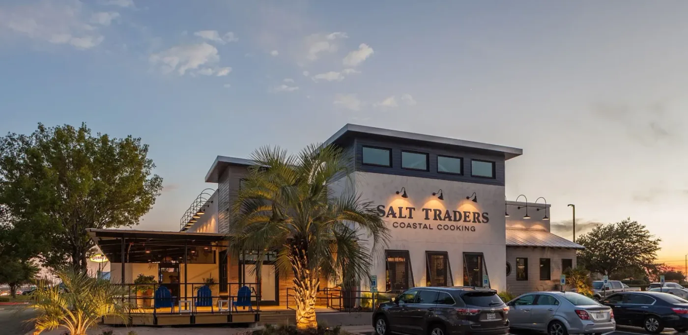 Restaurant exterior at dusk. Salt Traders Coastal Cooking.