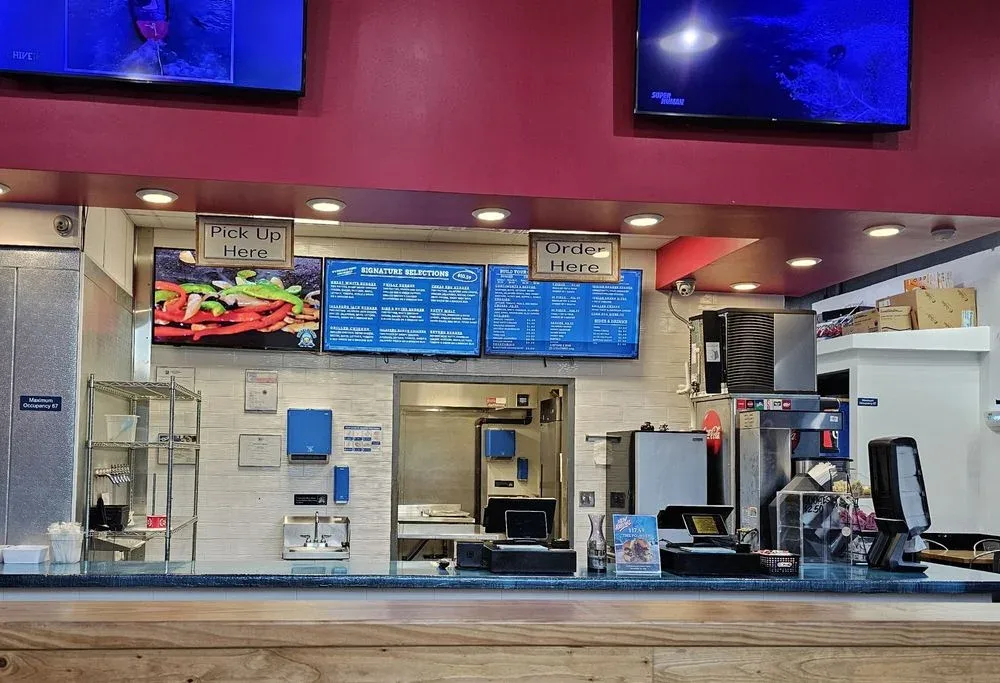Counter, menu boards and order area. Sharks Burger - Ronald Reagan.