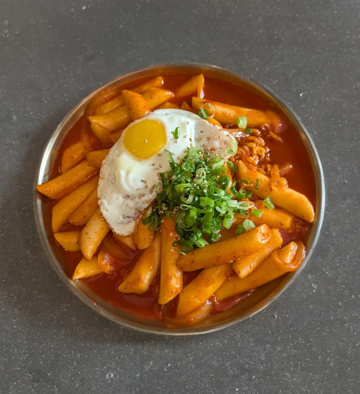 Tteokbokki topped with an egg at Ghama Zone