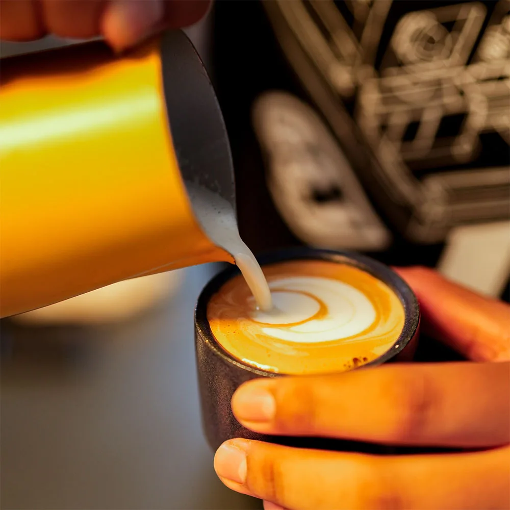 Coffee being poured at Mercado Sin Nombre
