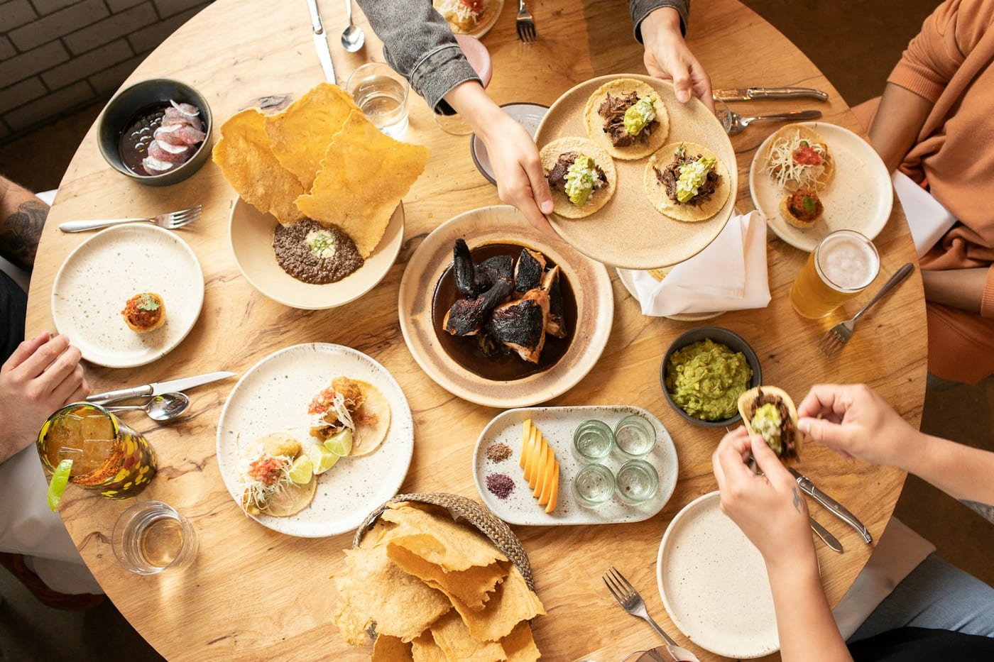 A table of Mexican dishes, tortillas and drinks at Suerte
